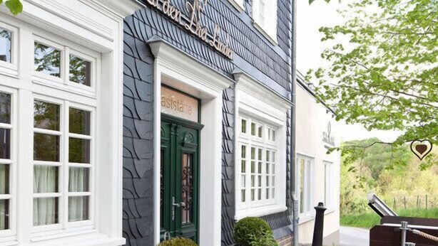 A building with a dark facade and white trim, featuring a sign that reads "Luden's". - Zu den Drei Linden (Wermelskirchen)