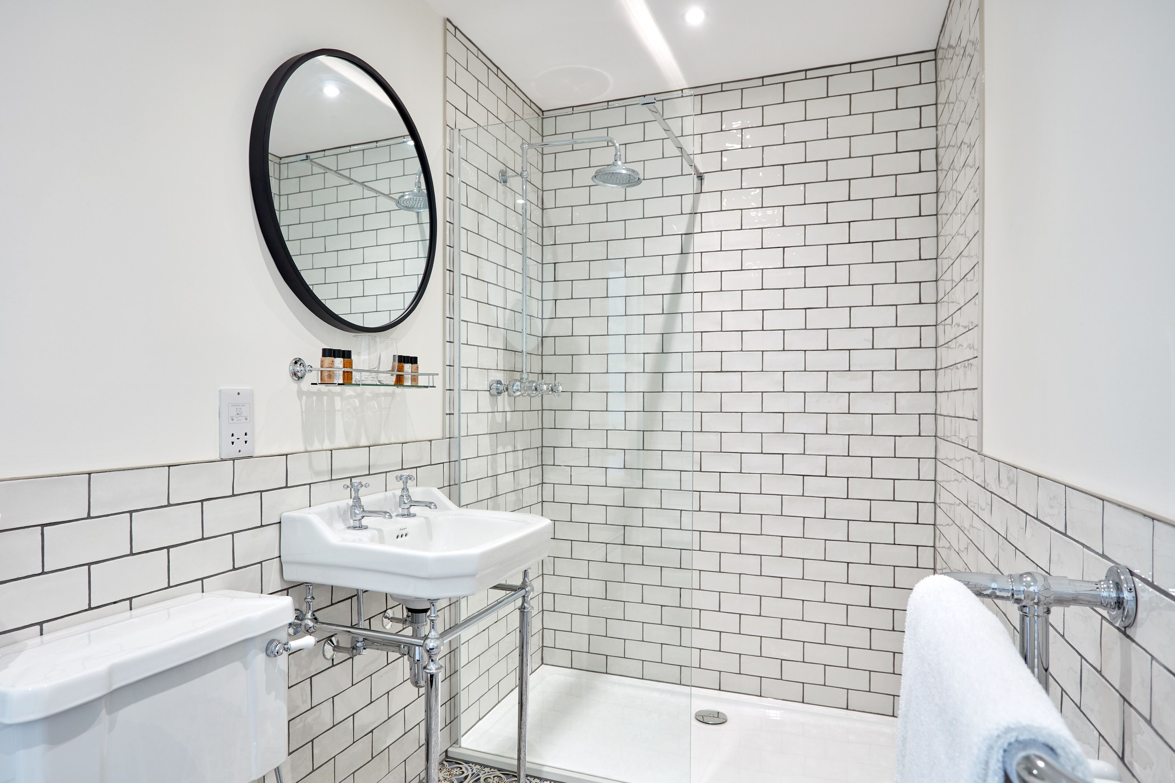 combined shower/bathtub, designer toiletries, hair dryer, towels