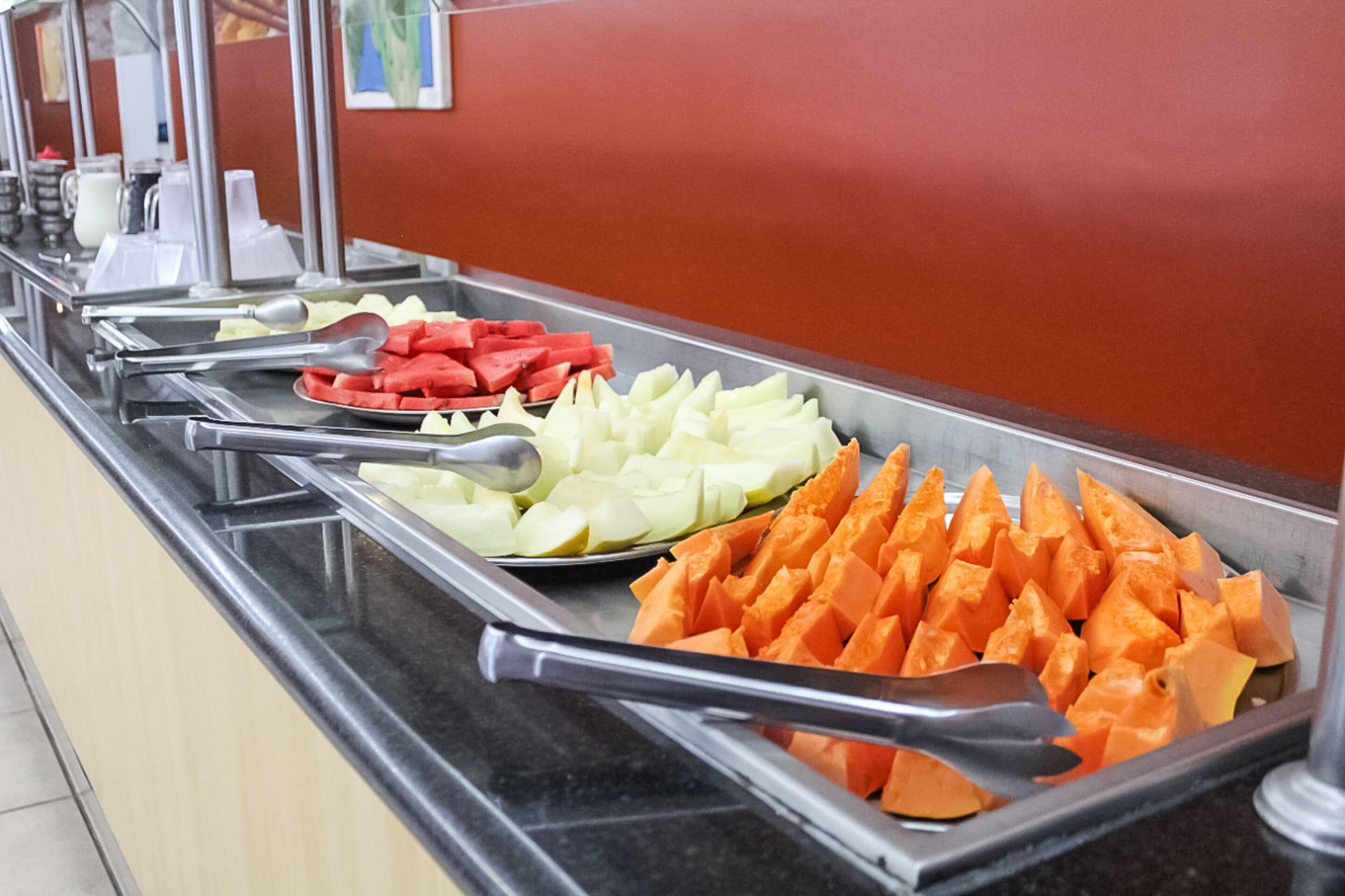 A buffet with various fruits and vegetables.