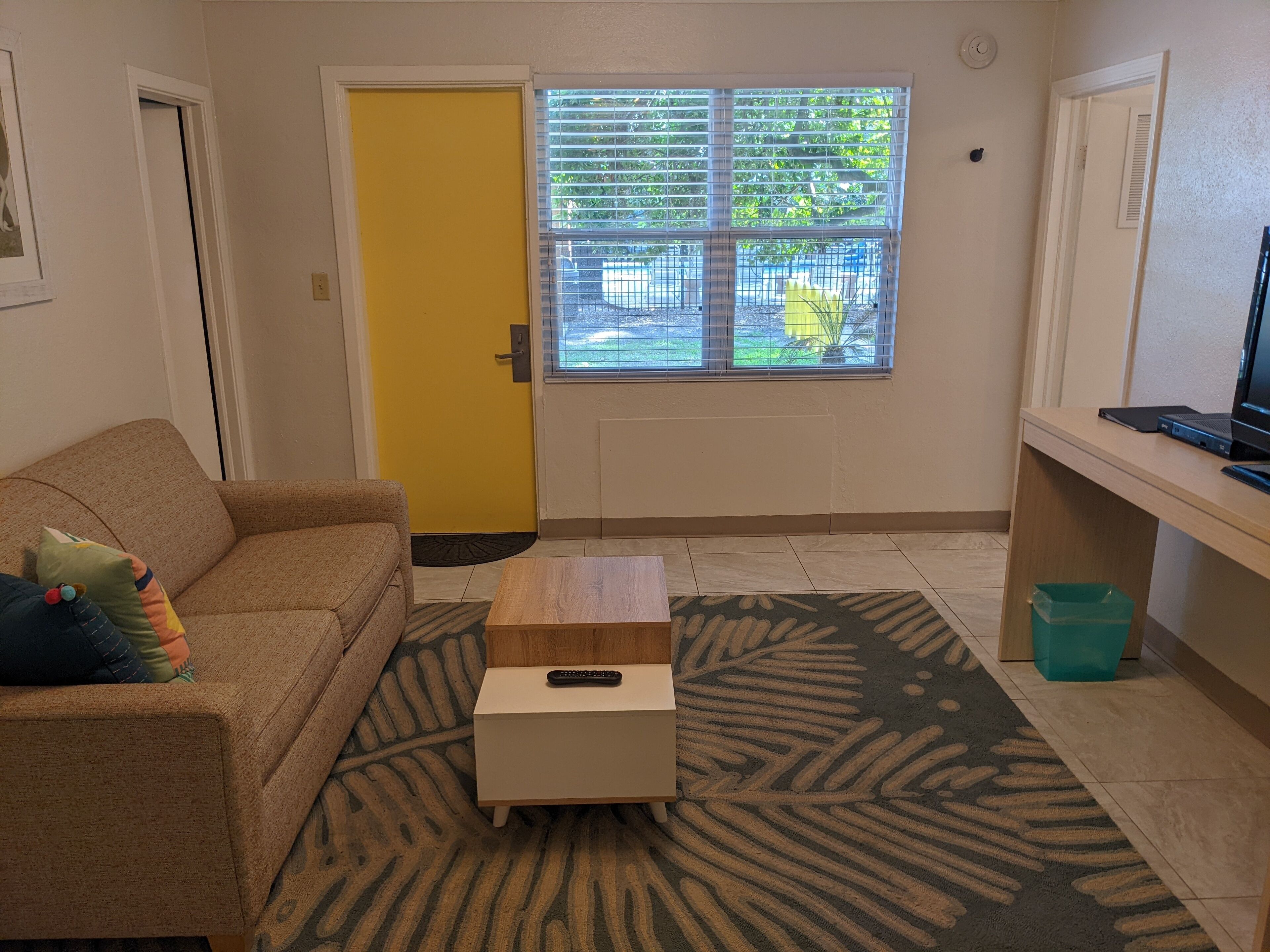 deluxe room, multiple beds | living area | flat-screen tv