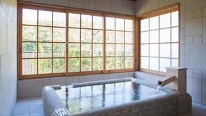 A spa room with a large window, a hot tub, and tiled flooring. - Miyama Sanso (Minamioguni)