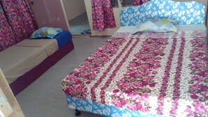 Une chambre à coucher avec un lit, un canapé et une couvre-lit à motifs.
