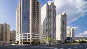 A high-rise building with multiple floors, large windows, and a modern architectural design.