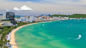 A coastal cityscape with a beach, boats, and buildings. - The LD Pattaya (Pattaya)