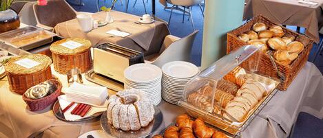 A buffet setup with various food items and dining ware.