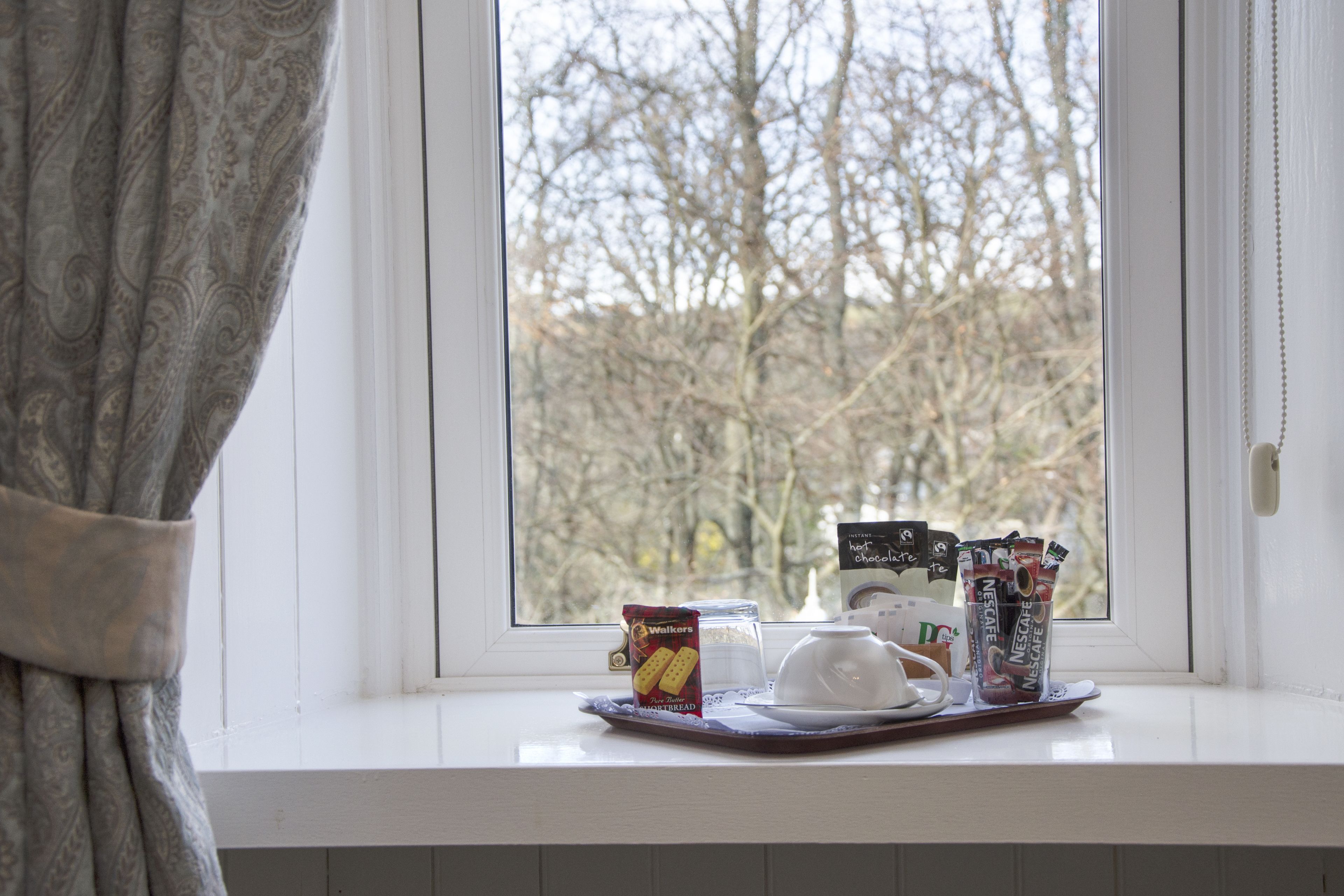 A tray with food items on a windowsill.