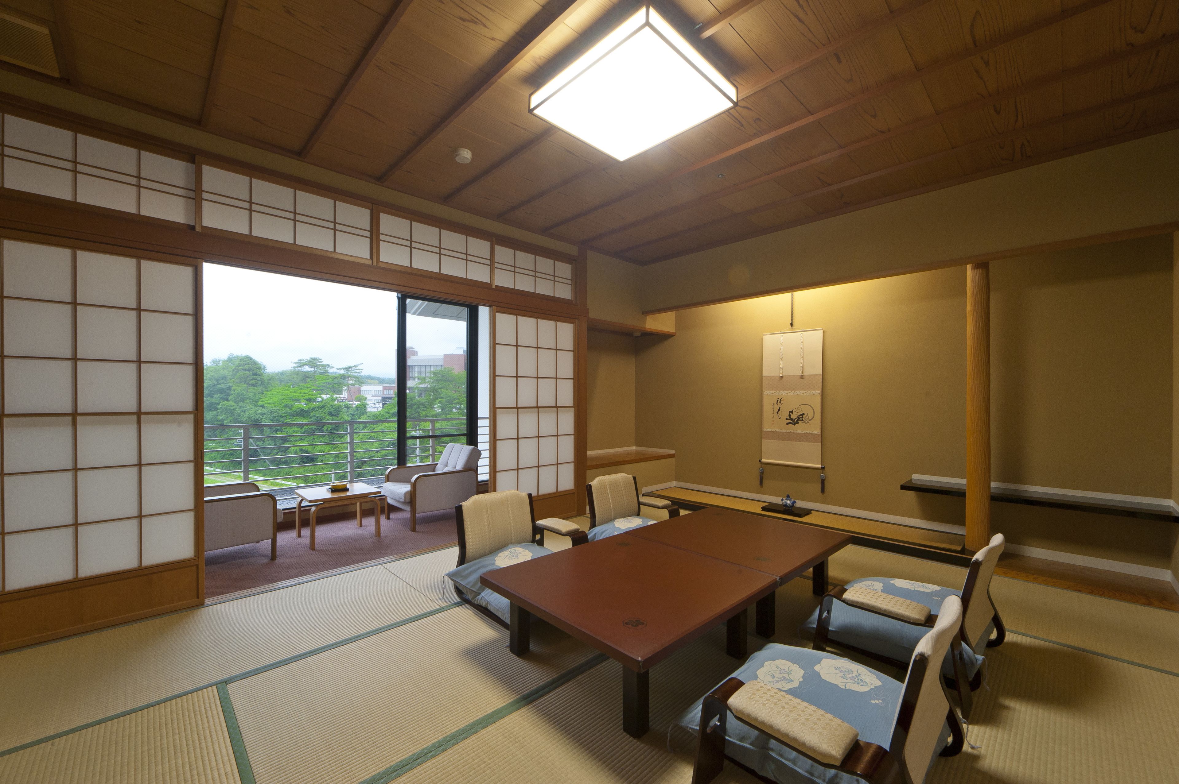 A traditional Japanese room with tatami flooring, a low table, and shoji screens.