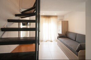 Quadruple Room (Split Level) | Living area | Plasma TV - Pension Avocado (Skiathos)