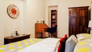 A bedroom with a bed, a wooden desk, a chair, a bookshelf, and a wooden wardrobe. - 1Br Apt In City Center by Minnehaha Lofts (Riga)