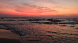 A beach at sunset with waves and a clear sky. - Malu Banna (Aluthgama)