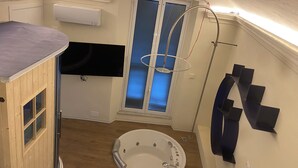 A bathroom with a bathtub, a shower, a toilet, and a sink.