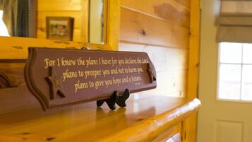 A wooden plaque with a quote on a wooden counter.