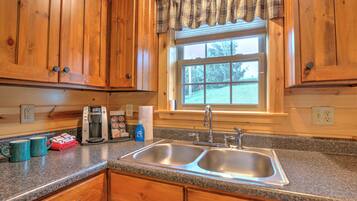 Fridge, microwave, coffee/tea maker, cookware/dishes/utensils