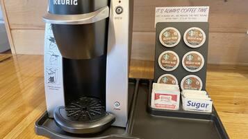 A Keurig coffee maker with a coffee pod holder displaying various Starbucks coffee pods.