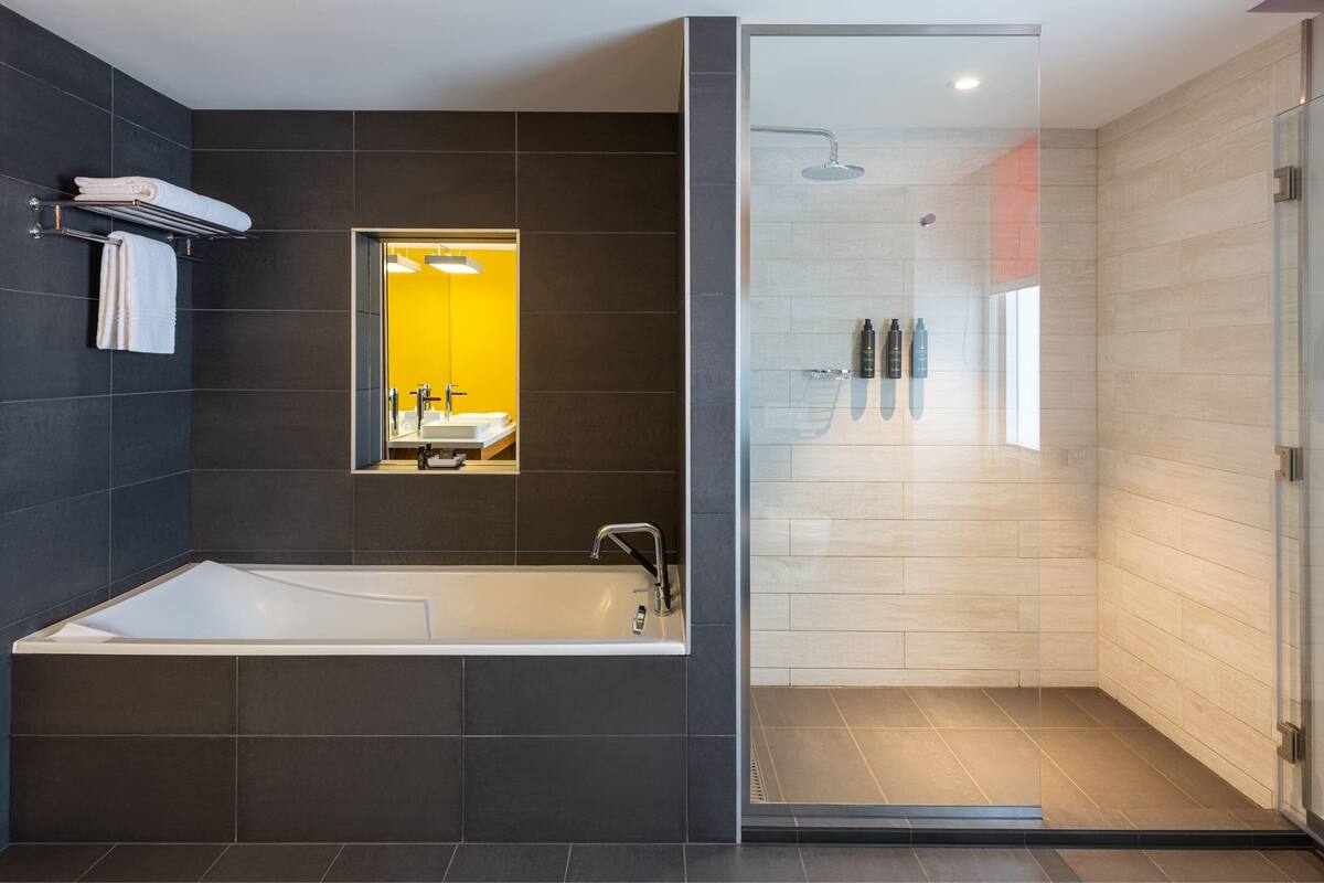 breezy, suite, 1 king bed | bathroom | free toiletries, hair dryer, bidet, towels