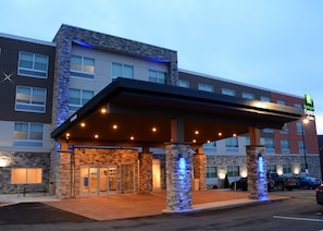 A Holiday Inn Express building with a covered entrance, stone facade, and multiple windows. - Holiday Inn Express & Suites Pittsburgh - Monroeville by IHG (Monroeville)