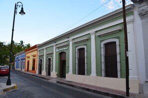 A row of colorful buildings with a sign for 'Hotel Mercedes' on the green building.