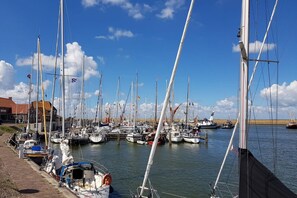 Boats of various sizes and designs are docked along the waterfront.