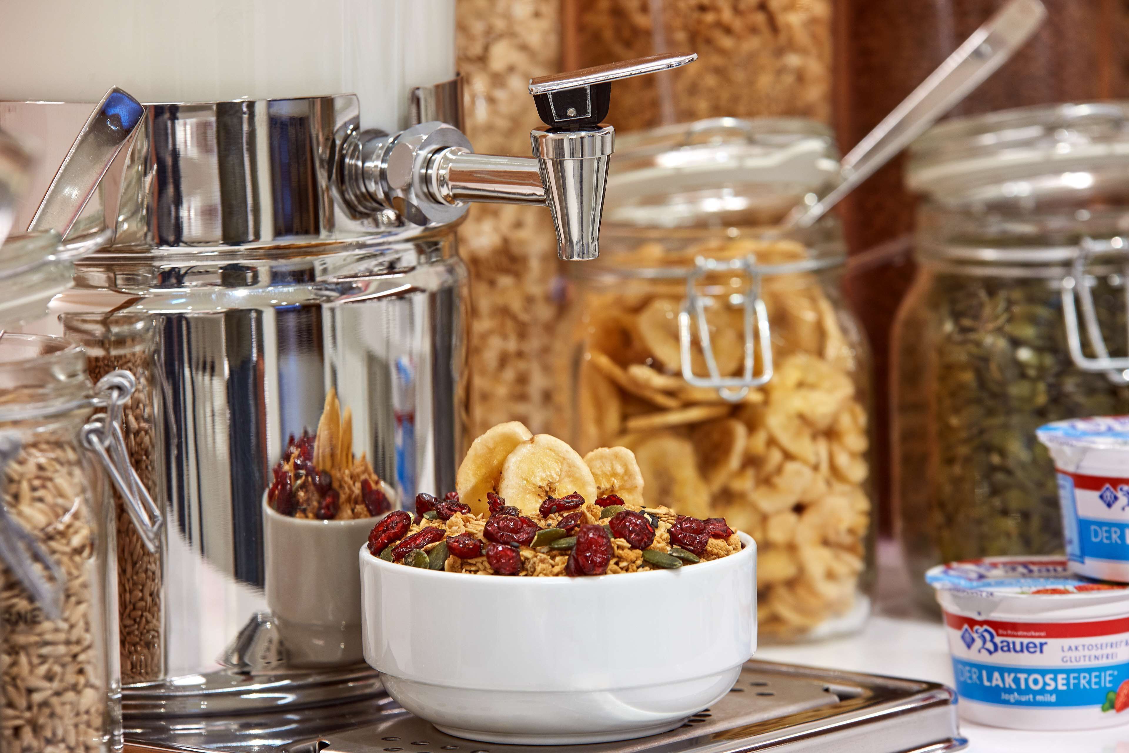 Un bufé de desayuno con una variedad de cereales, frutas y productos lácteos.
