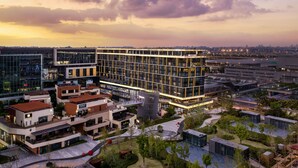 A modern urban building complex with multiple floors, large windows, and a mix of commercial and residential spaces. - Cordis Shanghai Hongqiao (Shanghai)