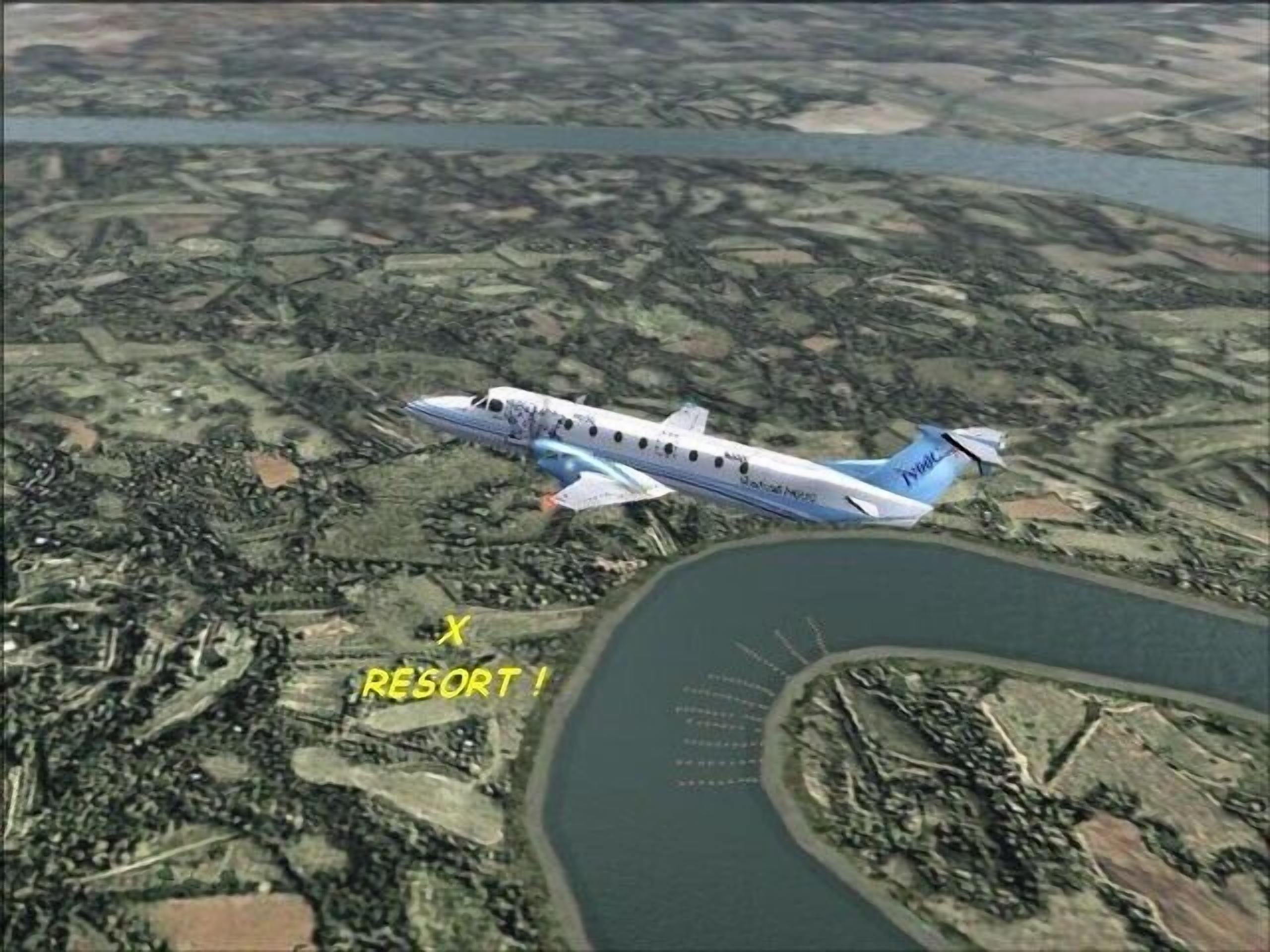 Un jet privado volando sobre una zona turística con una masa de agua y una carretera curva.