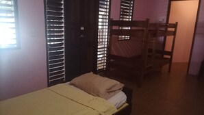 A room with a bed, a bunk bed, and a window with blinds. - Bluepango Guest House - Hostel (Port Vila)