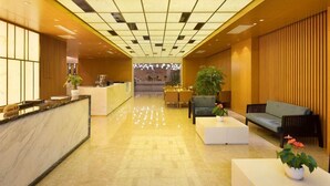 A hotel lobby with a reception desk, seating area, and a view into the dining area. - Fliport Garden Hotel (Nanjing Lukou Airport Branch) (Nanjing)
