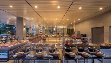 A buffet setup with multiple food stations, including hot pots and a variety of dishes.
