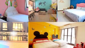 A hotel room with a bed, a desk, and a chair. There is a window with curtains and a view of the outside. - Have FUN villa (Hengchun)