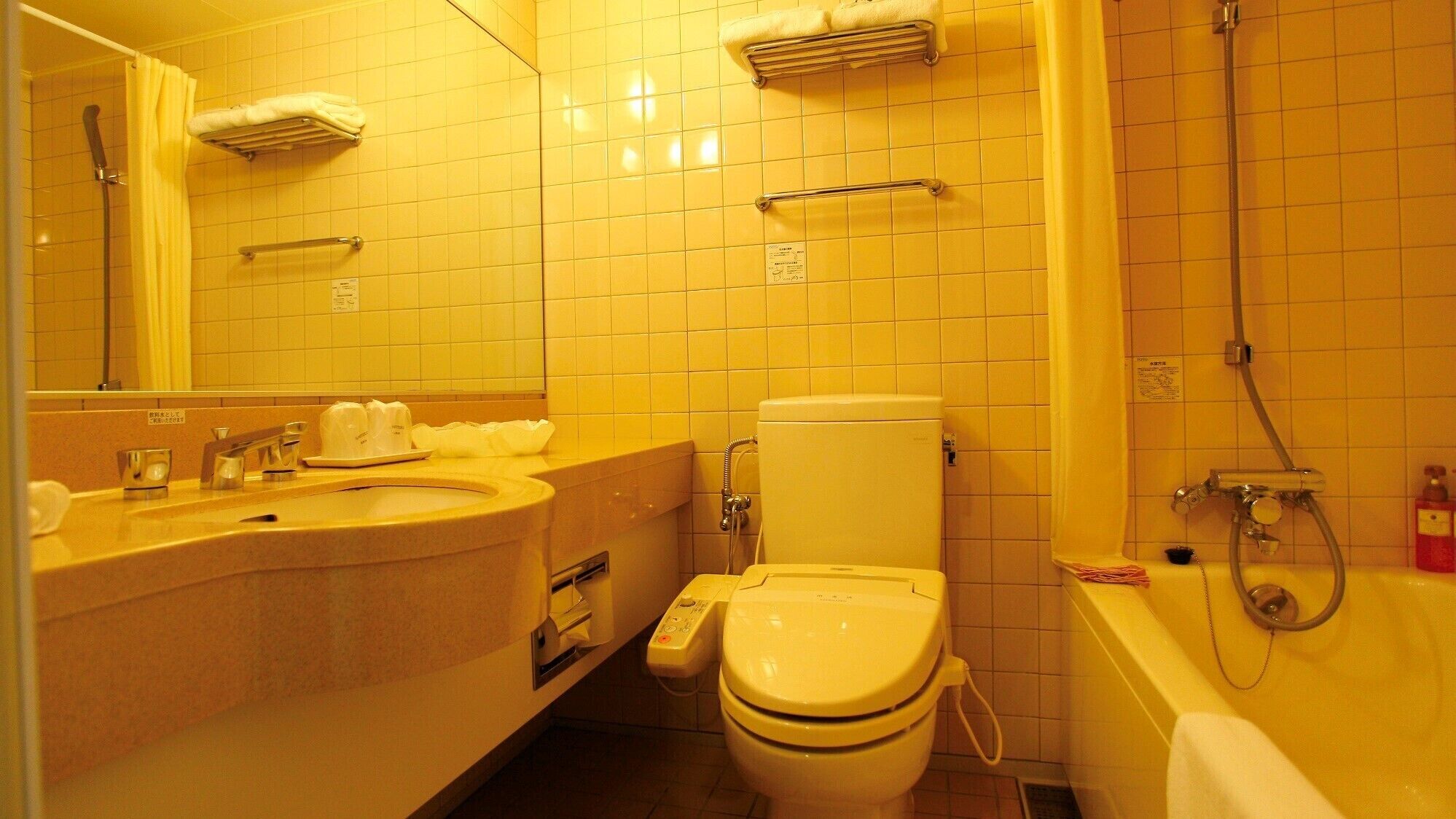 A bathroom with a sink, toilet, and shower.