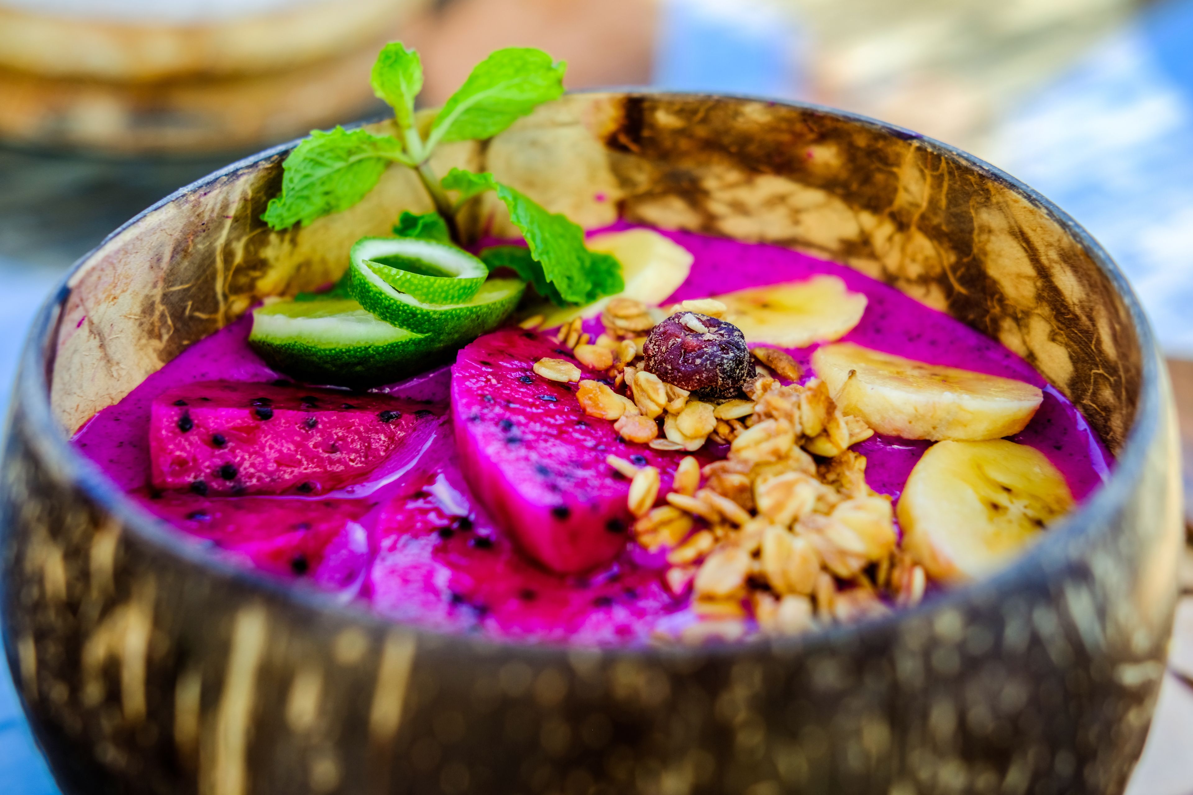 A bowl of colorful fruit and granola.