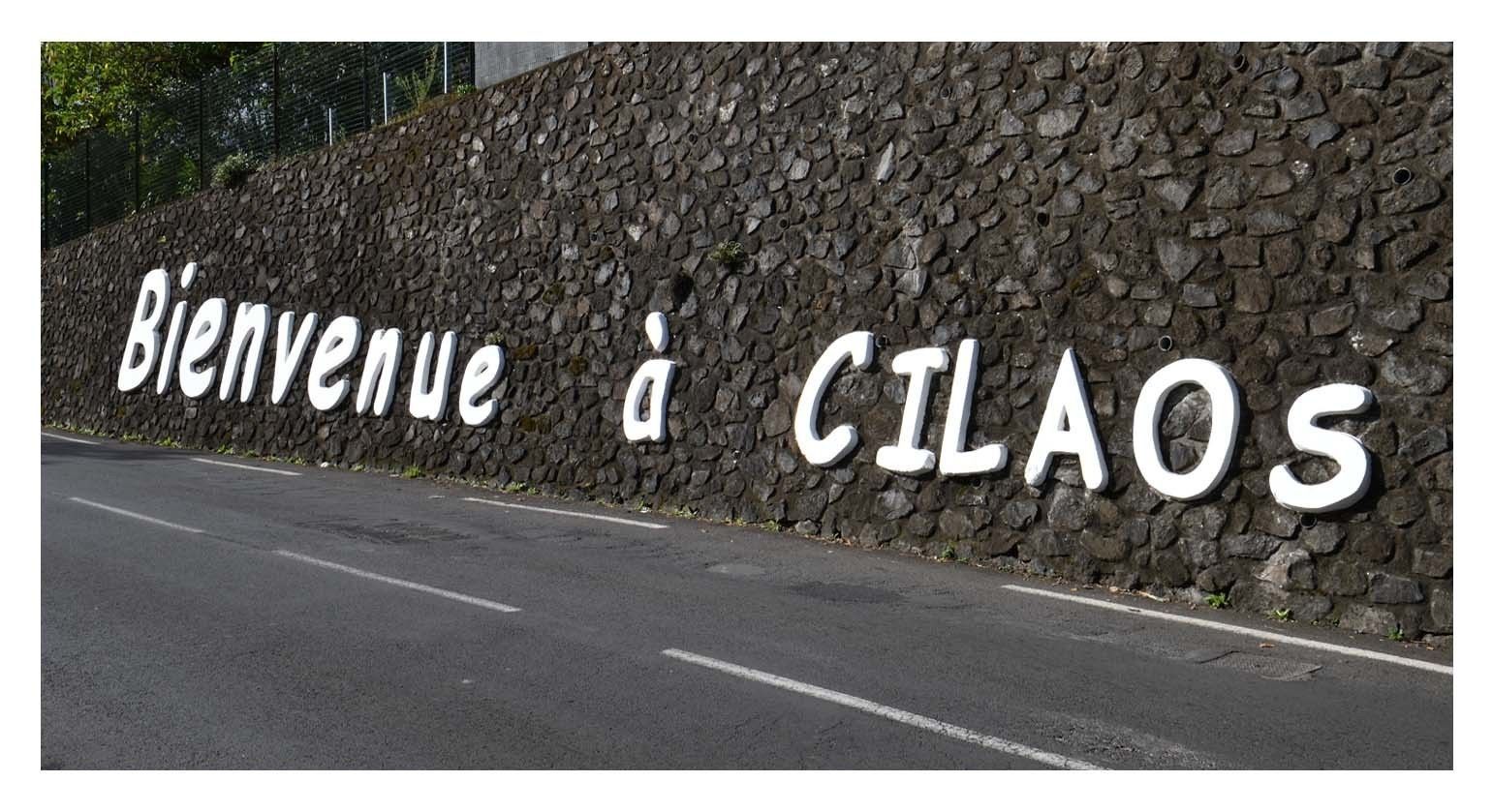 Un mur de pierre sur lequel on peut lire en lettres blanches : « Bienvenue à Cilaos ».