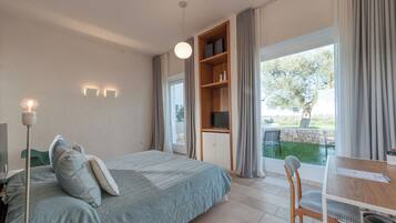 Deluxe Room, Patio, Garden Area | Premium bedding, minibar, in-room safe, individually decorated