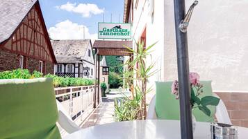 A restaurant named "Gasthaus Tannenhof" with a view of the street and traditional buildings.
