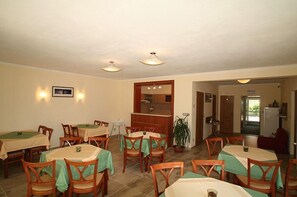 Guests can dine in comfort at this elegant space, featuring tables and chairs for a relaxed meal.