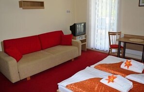 Relax in this inviting space with a comfortable sofa, dining table, and flat-screen TV.