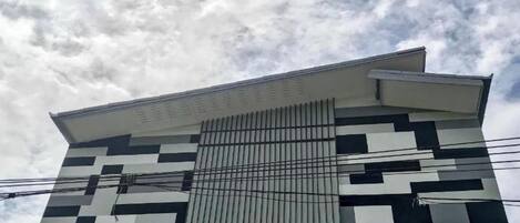 Un edificio moderno con fachada geométrica y techo inclinado.