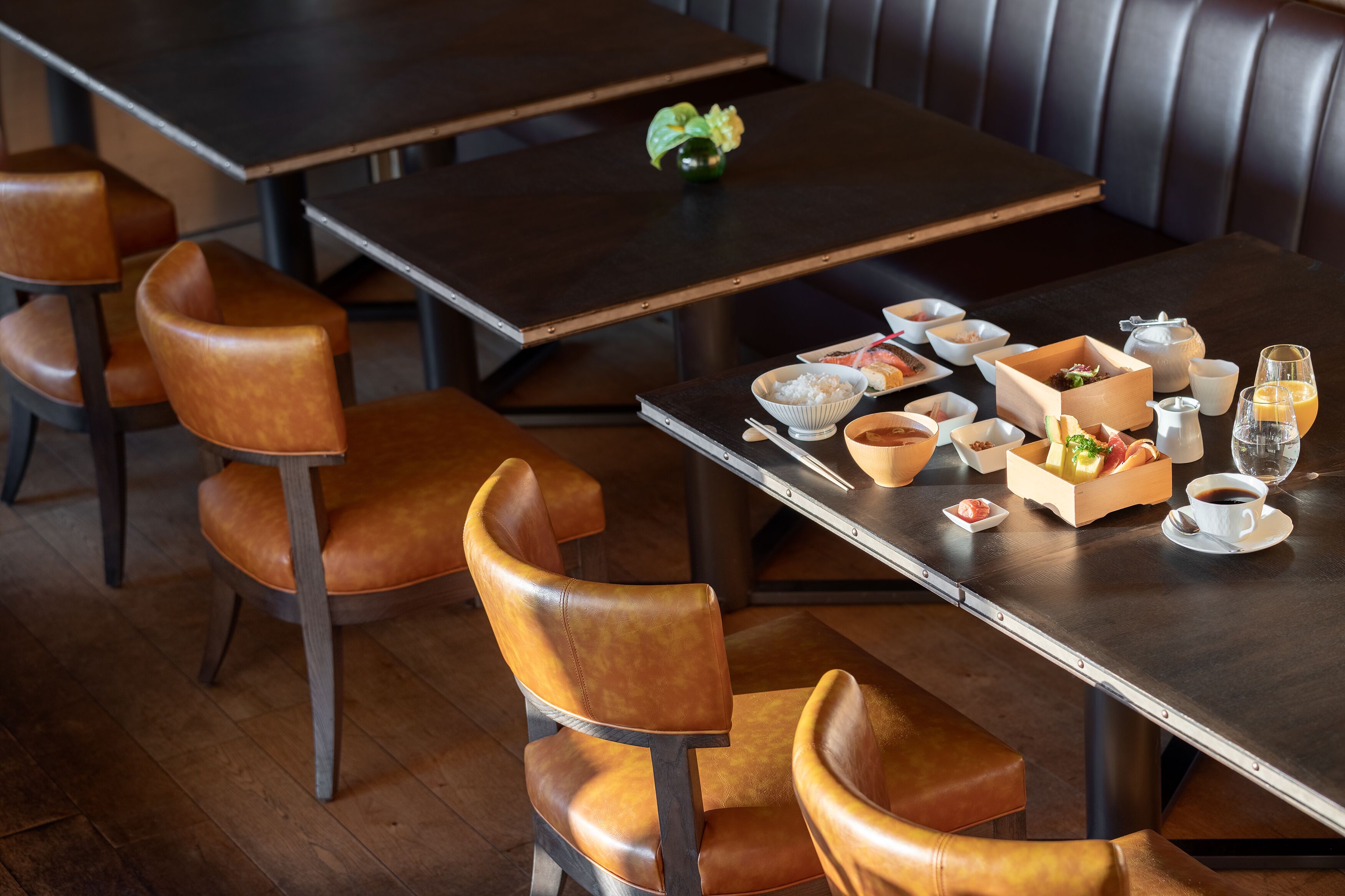 Un restaurante con mesas de madera y sillas de cuero.