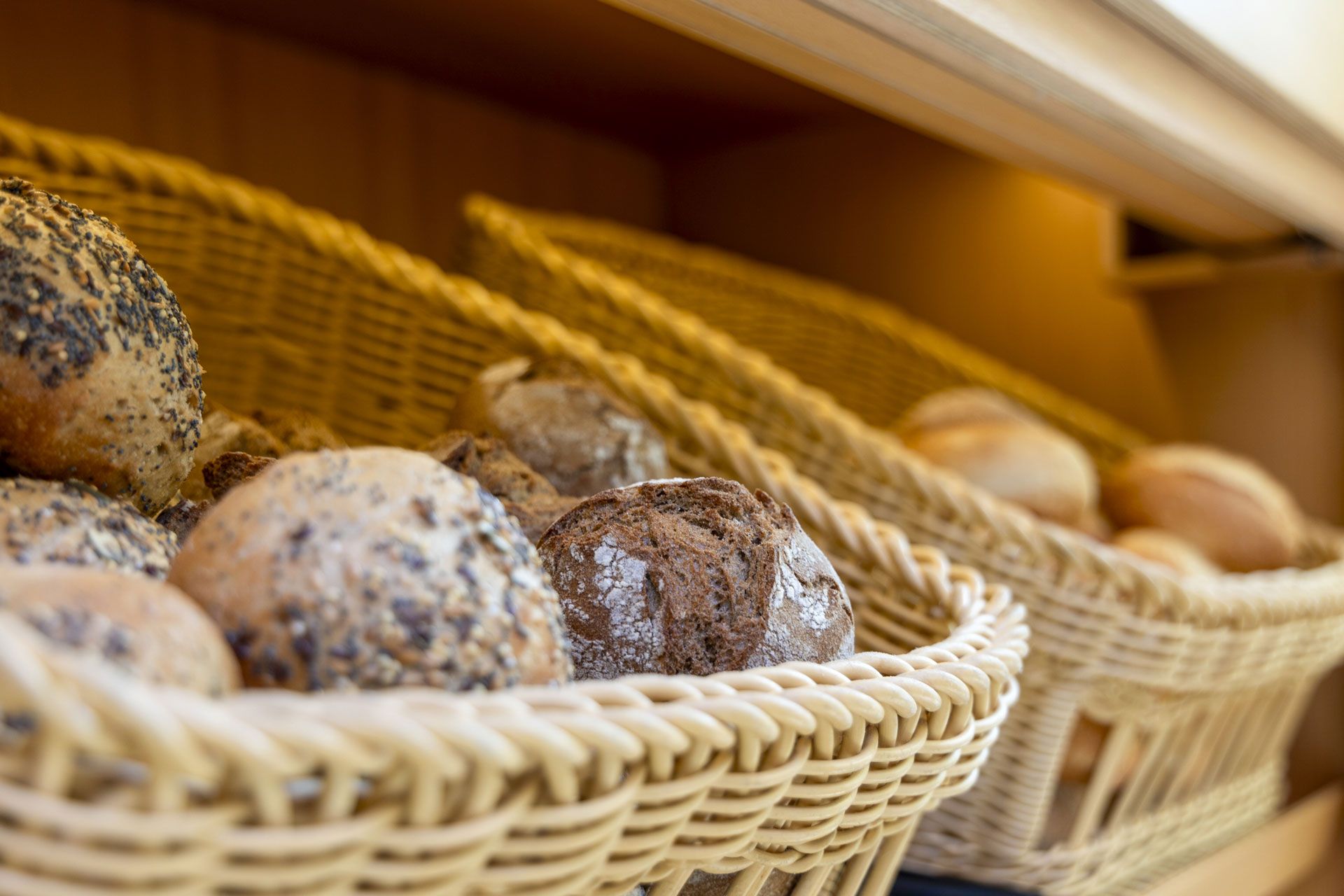 A basket filled with various types of bread.