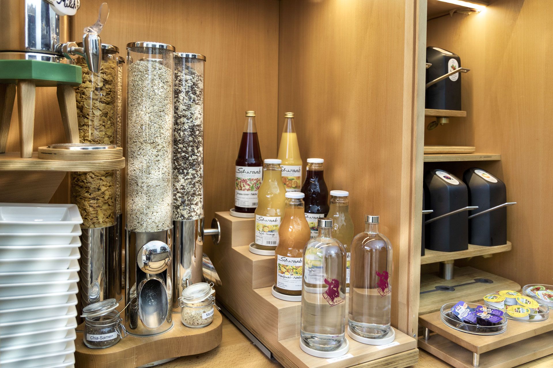 A kitchen area with various food items, including jars of spices, bottles of sauces, and condiments.