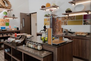 A breakfast buffet with various food items and containers. - Hampton Inn Celaya Mexico (Celaya)