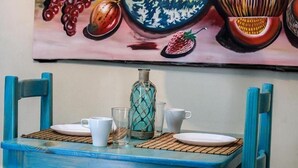 A dining table with two chairs, a bottle, and two cups. - Hotel Tronco Inc (Boca Chica)