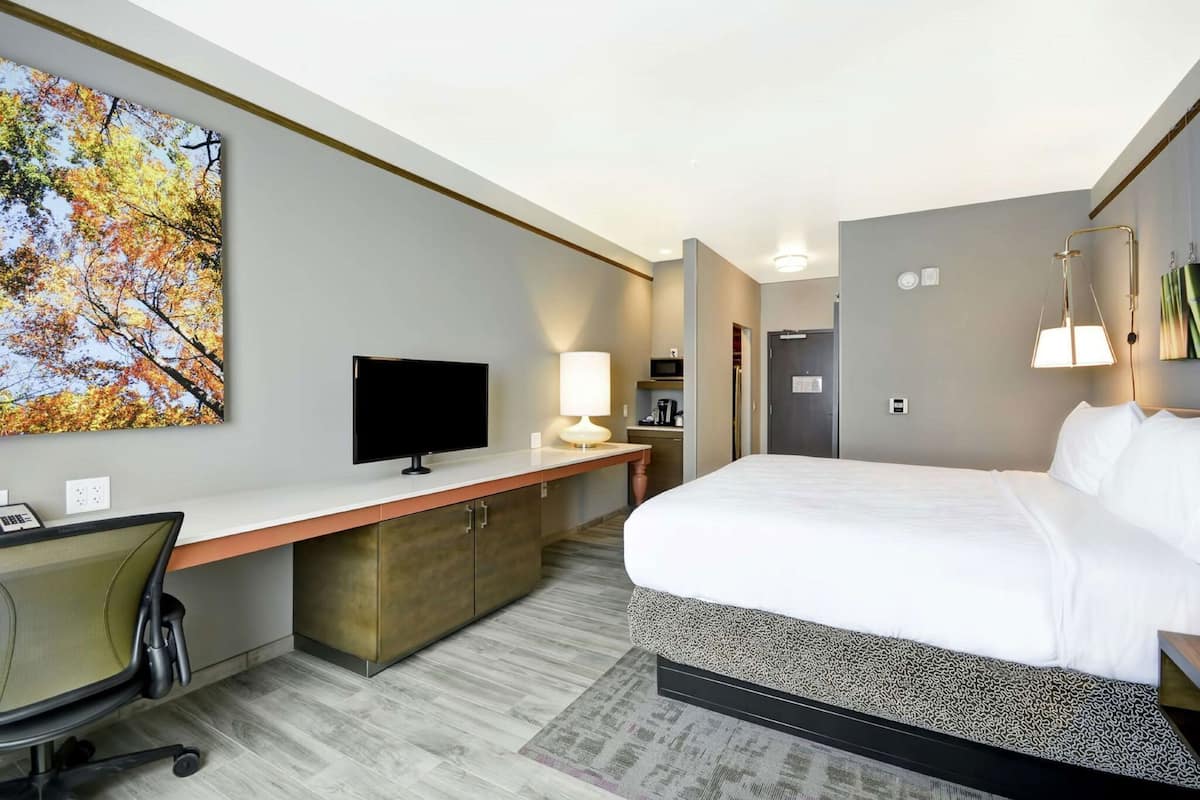 Premium bedding, desk, laptop workspace, iron/ironing board