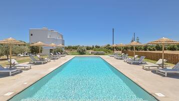 Seasonal outdoor pool, open 8:30 AM to 8:30 PM, pool umbrellas