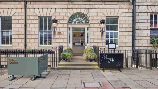 A building with a stone facade, a central entrance with a fanlight, and a signboard with the name 'Mayo.' - Eden Locke (Edinburgh)