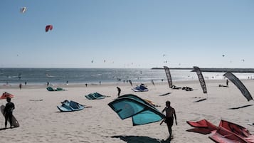 On the beach, windsurfing