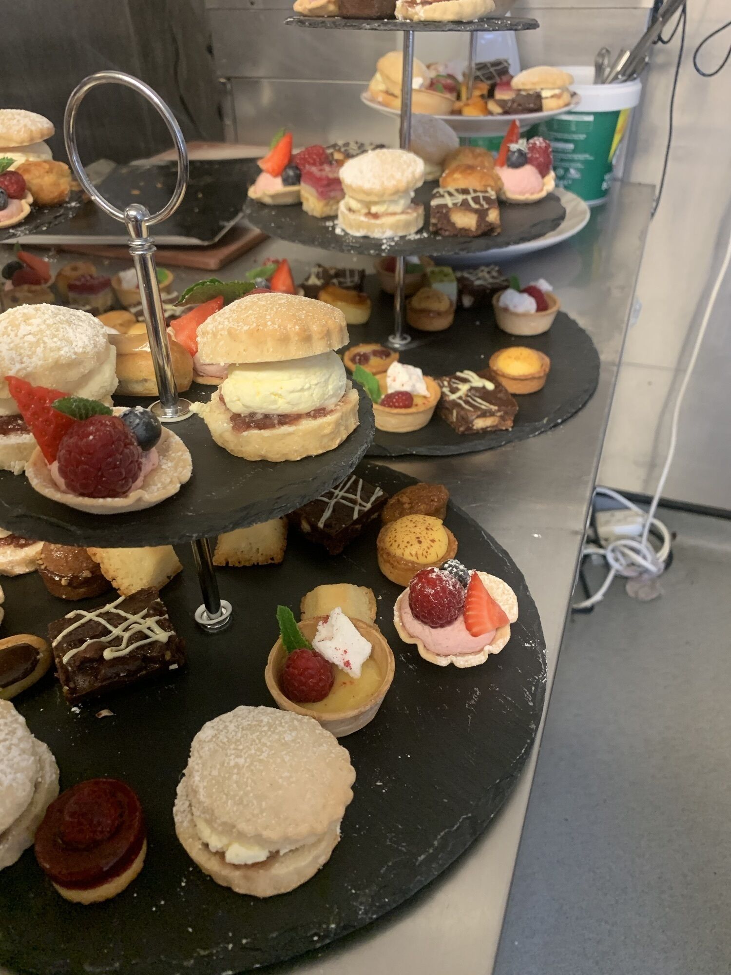 A multi-tiered display of assorted pastries and desserts.