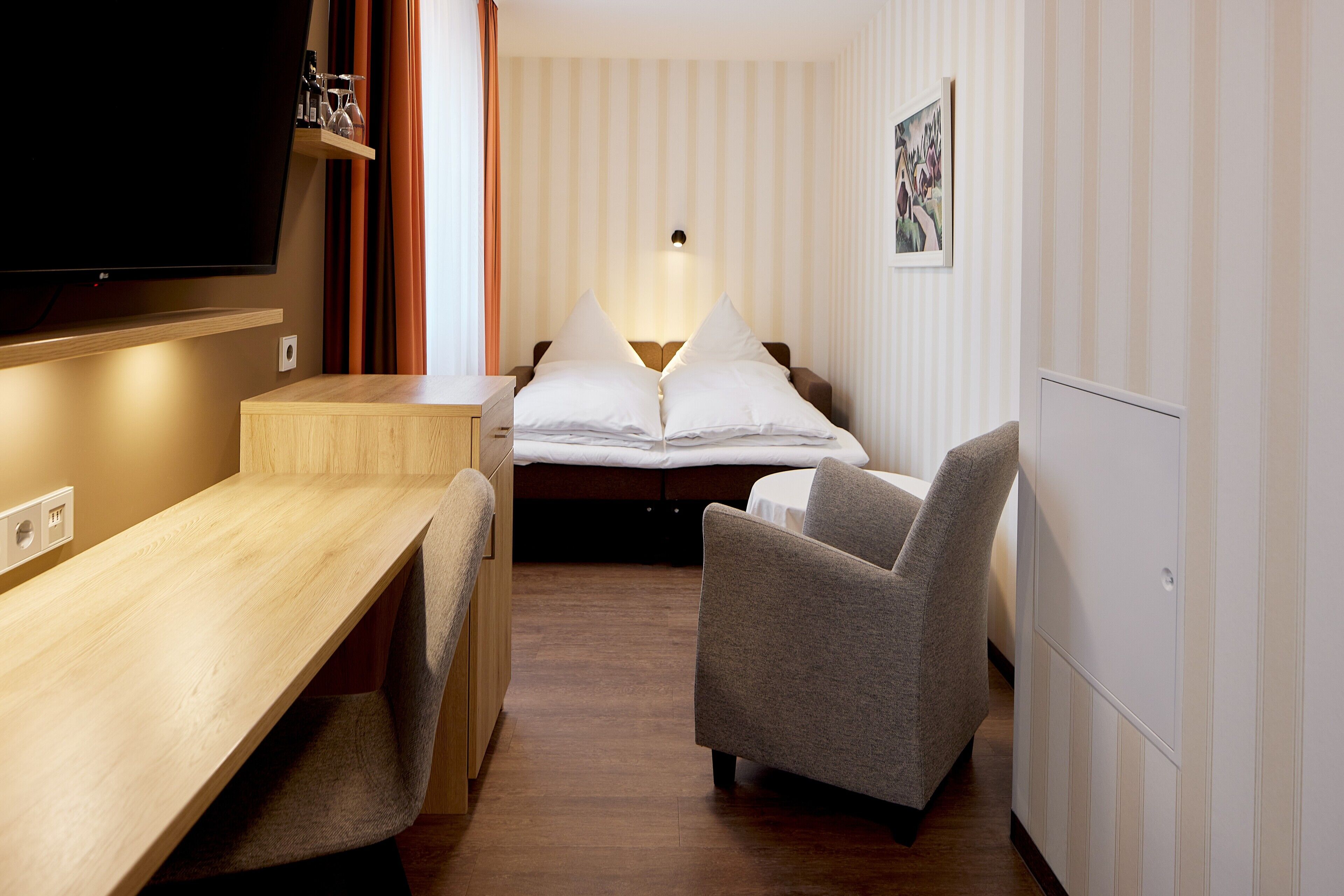 family room | 1 bedroom, minibar, in-room safe, desk