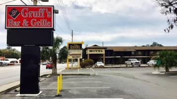 A Gruff's Bar & Grill sign, a motel, and a vacant signboard.