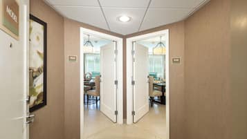 A hallway with double doors labeled 104A and 104B, leading to a room with a desk and chairs.